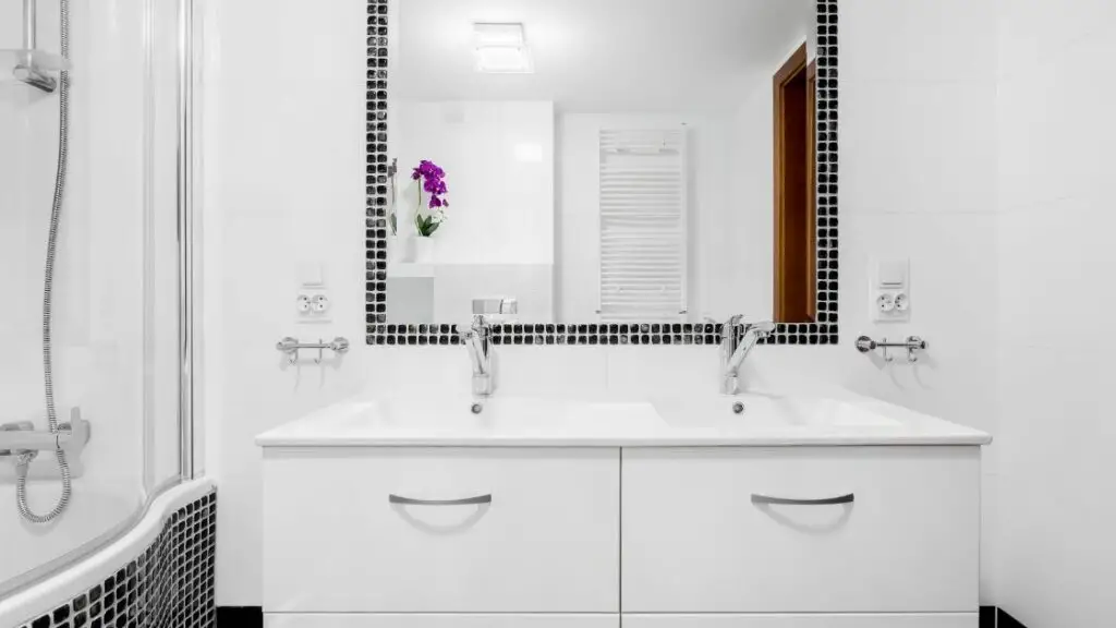 White bath with black tile